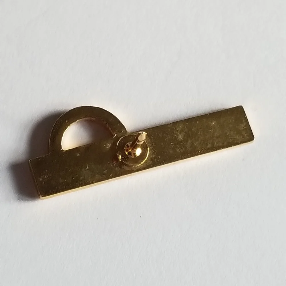 Mentor lapel pin Omega red enamel gold tone metal Greek symbol brooch